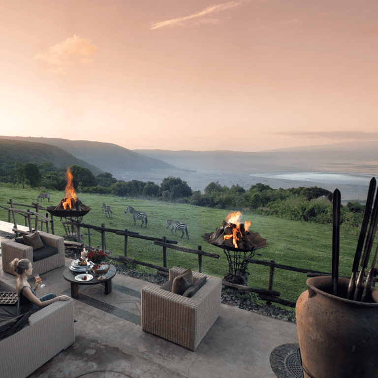 outdoor lounge area overlooking zebra and the valley and the ngorongoro crater below