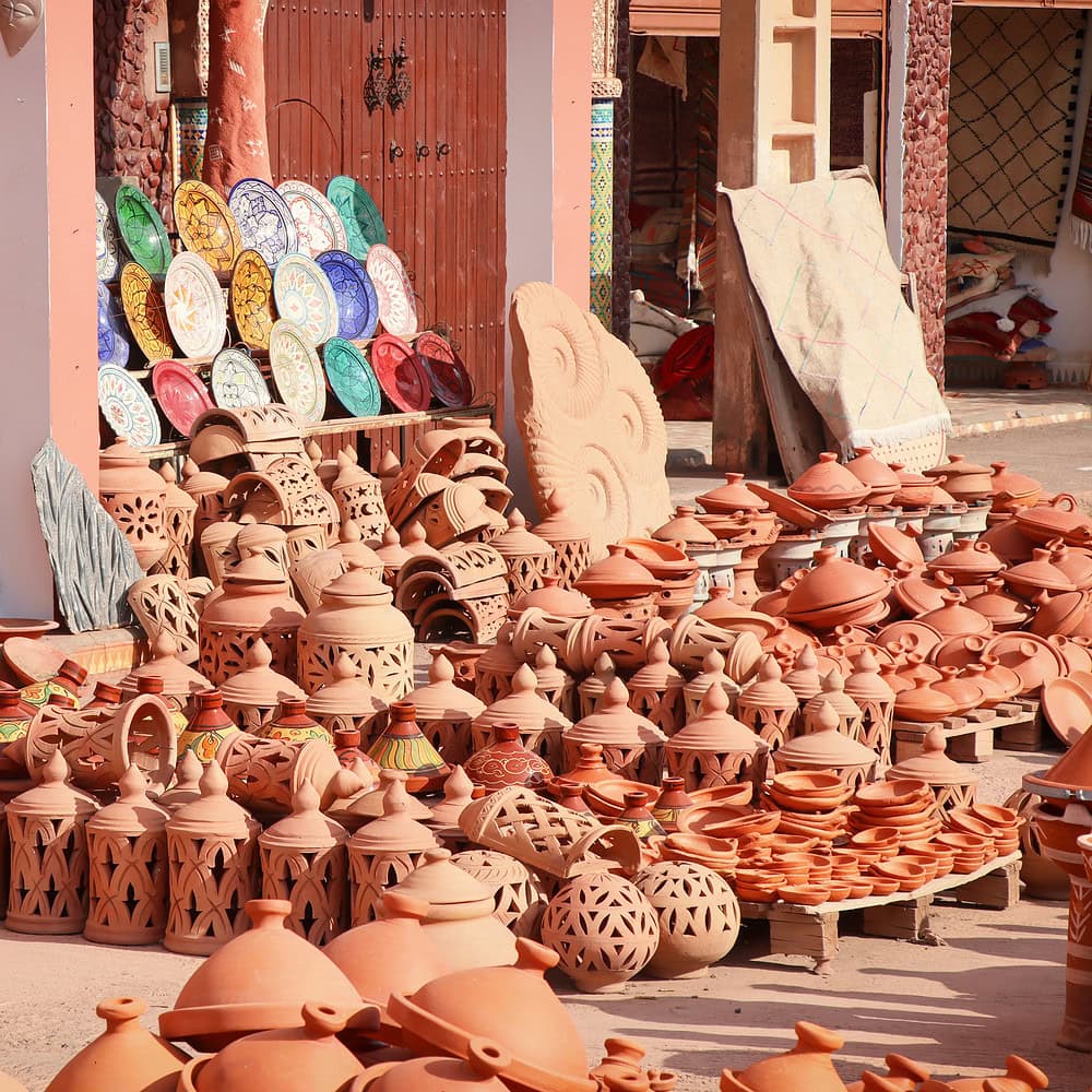 Clay products displayed for sale at a Moroccan market. Traditional pottery and handmade items reflecting Moroccan cultural and craft traditions.