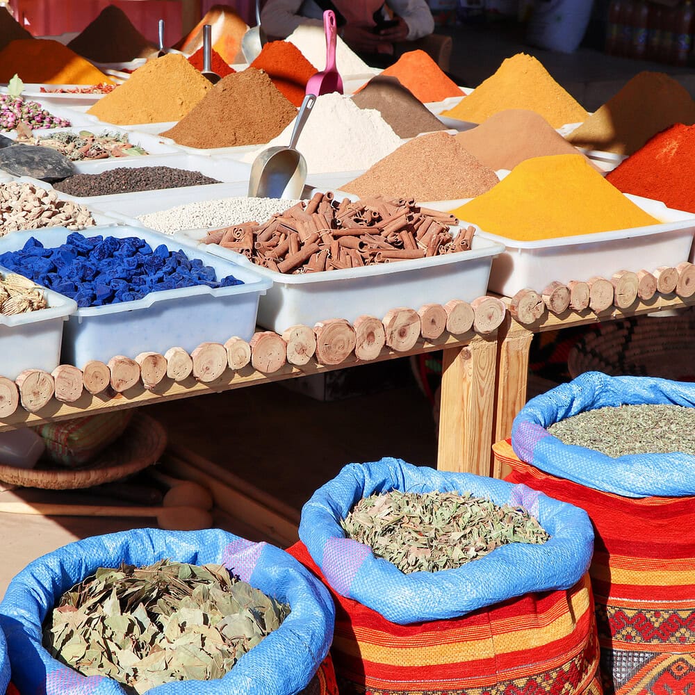 Variety of spices and traditional products at a Moroccan bazaar. Colorful display and authentic atmosphere of a traditional Eastern market.